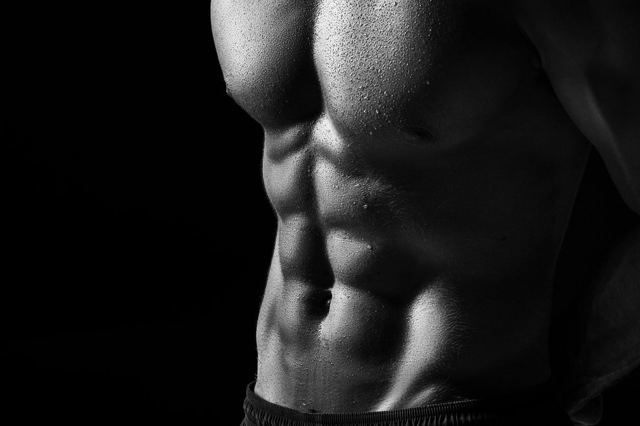 The Torso Of Attractive Male Body Builder On Black Background The Torso Of Attractive Male Body Builder On Black Background