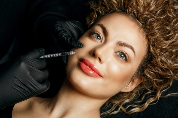 Positive Woman Getting Injection Into Her Face